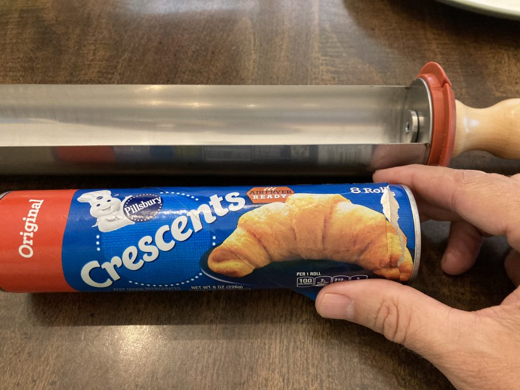 Sore-bought crescent rolls from a can, next to solar oven cooking tray.