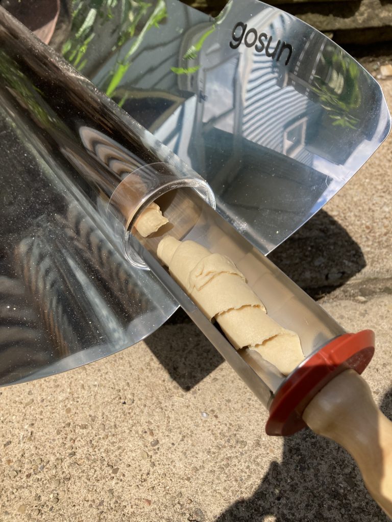 GoSun solar oven with croissant dough in the cooking tray.