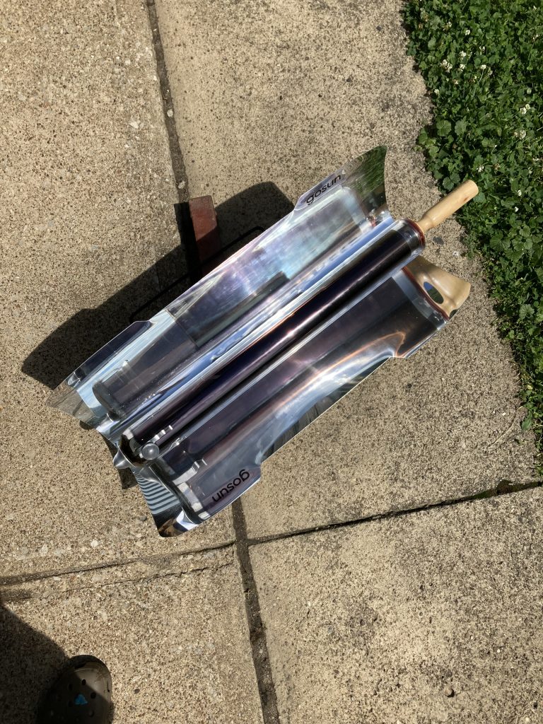 GoSun solar oven on the sidewalk, actively cooking.